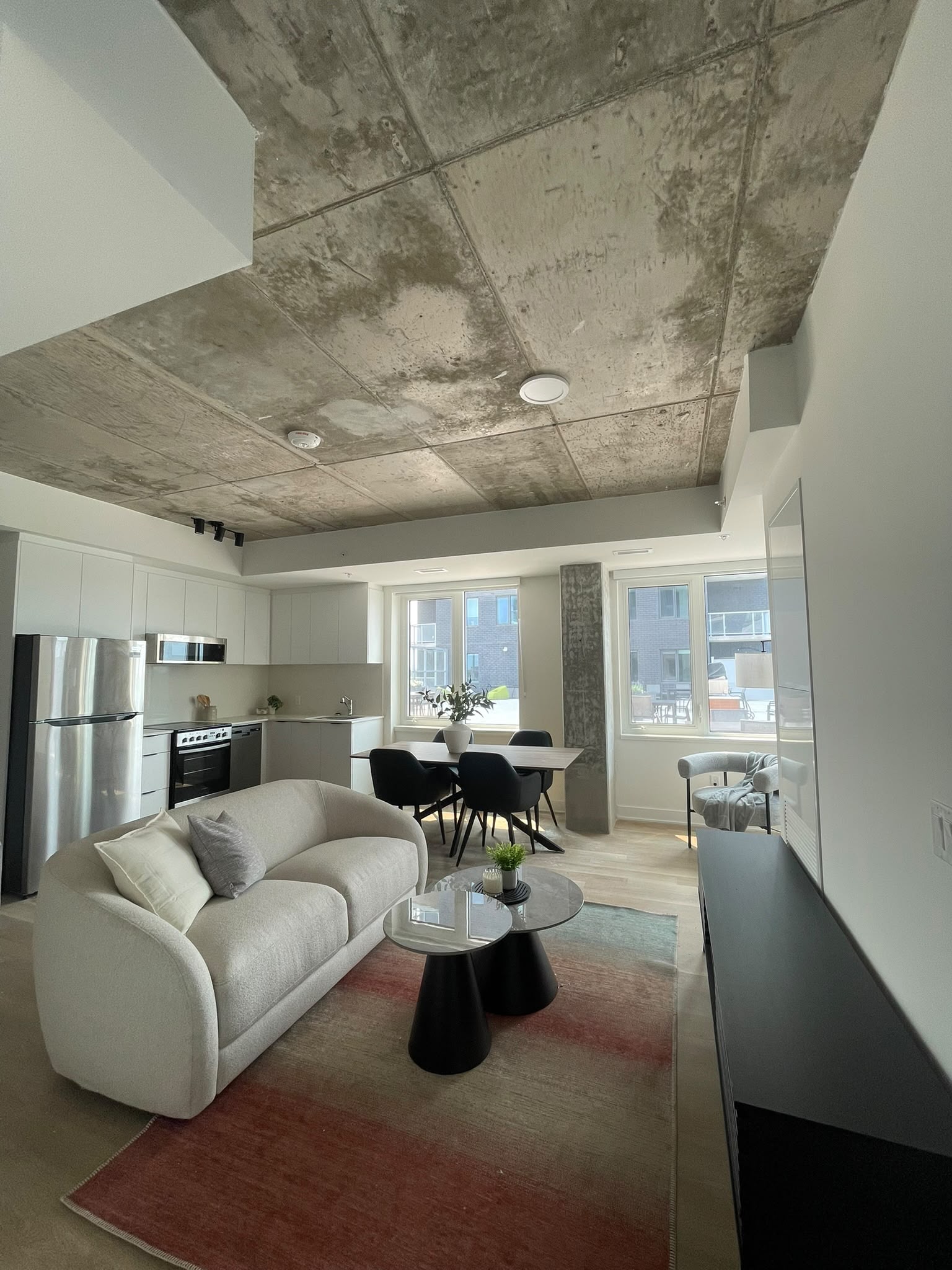 Open furnished apartment with living room, dining area, and kitchen arranged together