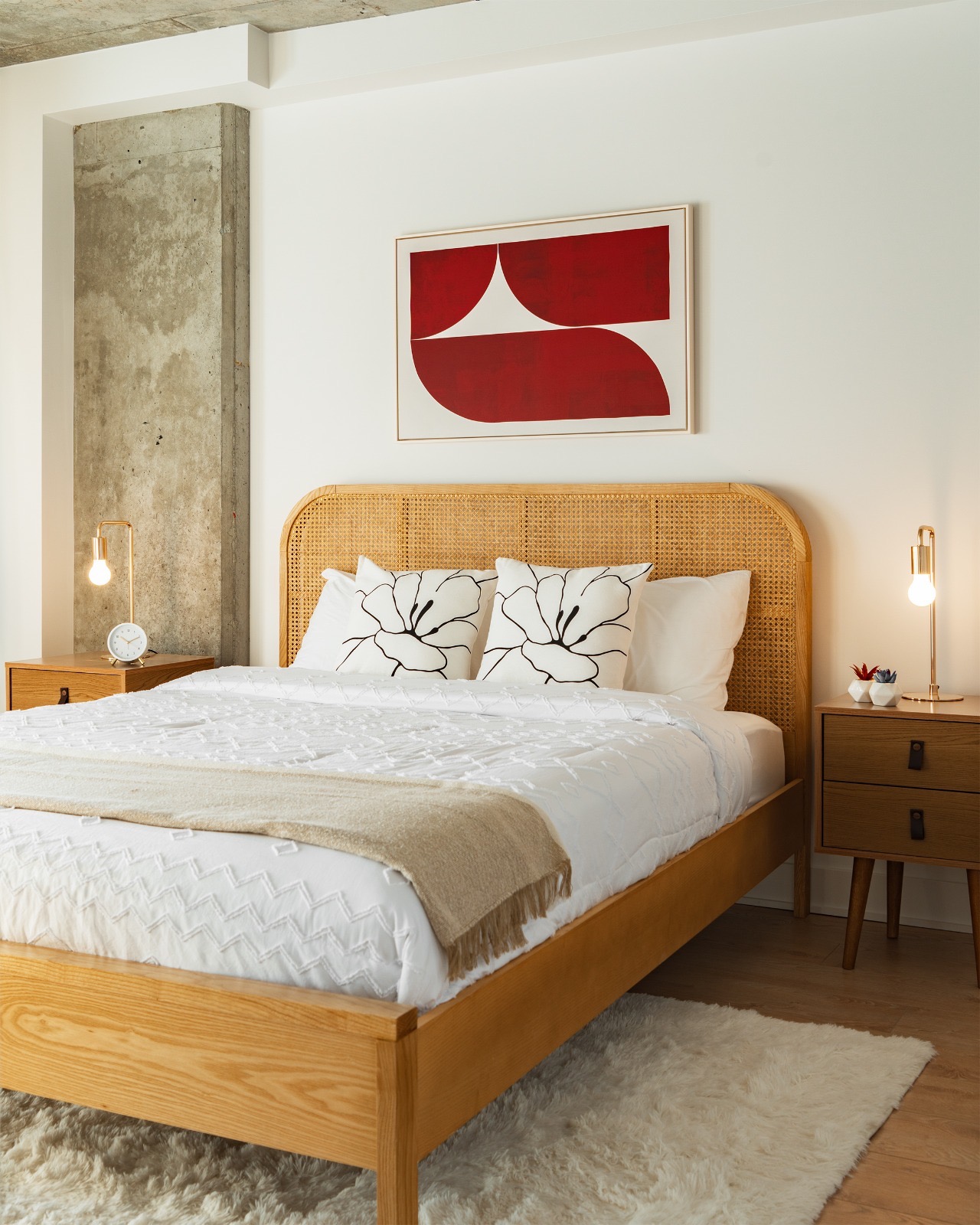 Finished second bedroom with oak furniture, linens, lamps, and art